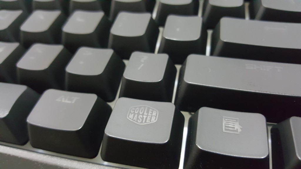 UV Coated keycap. And they have a CM logo to always remind you that they got your fingers.